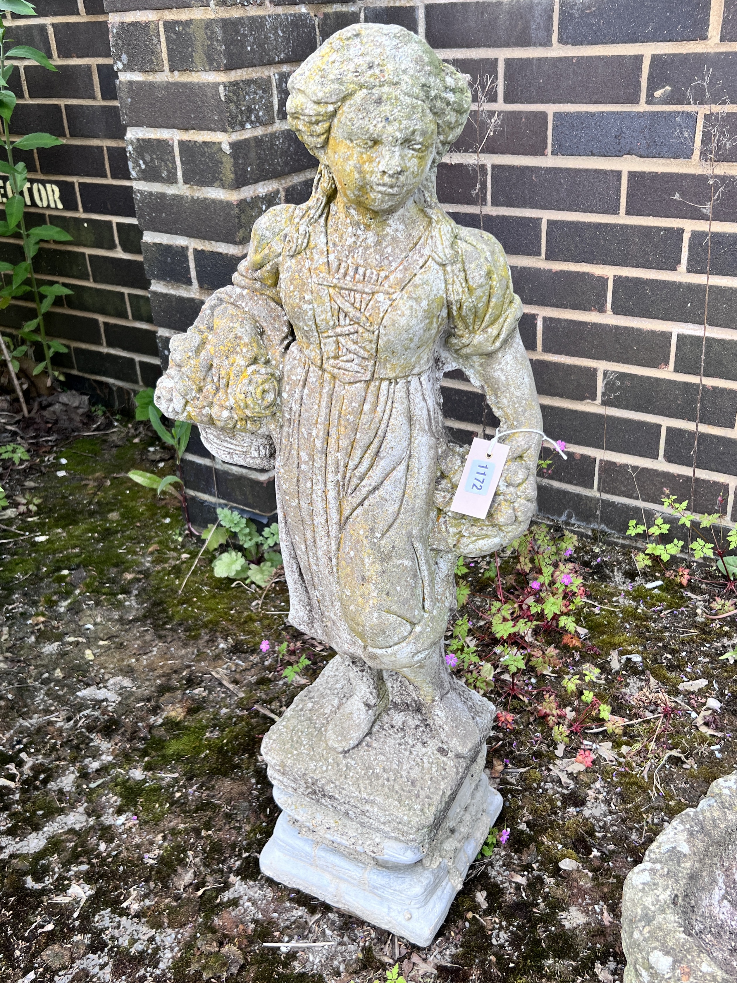 A reconstituted stone garden statue of a flower girl, height 90cm